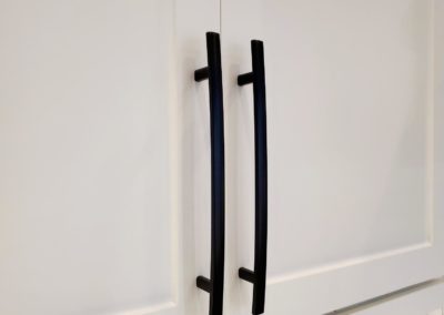 Flat Black Subtle Arch Handles on White Shaker Kitchen Cabinet Close Up