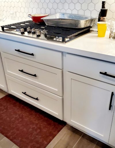 Flat Black Subtle Arch Handles on White Shaker Lower Kitchen Cabinets