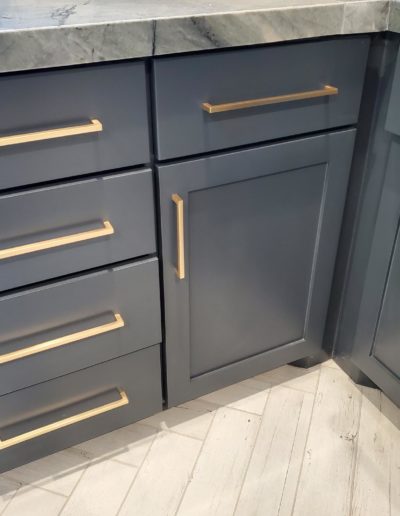 Brushed Brass Gold Thin Bar Pull Handles on Blue Grey